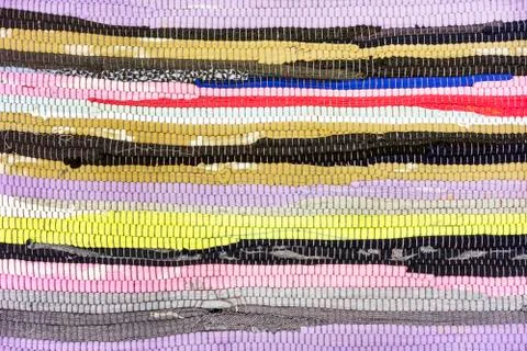 Rug of pieces of cloth. Texture and background of patchwork carpet. Stockfoto's