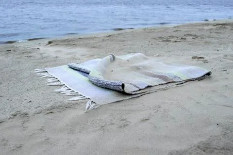 Rug in the sand on the beach. Stock Photos