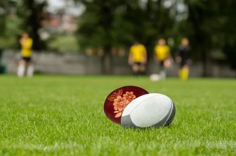 Rugby ball and easter egg at green grass Stock Photos