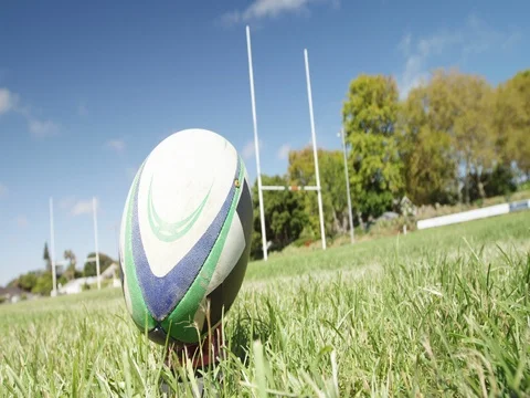 Rugby player kicking oval ball at a distance 4K 4k Stock Footage