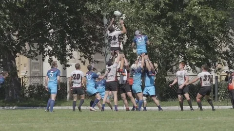 Rugby players jump to a ball - Slow Motion Stock Footage