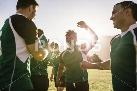 Rugby team rejoicing victory on sports field Stock Photos