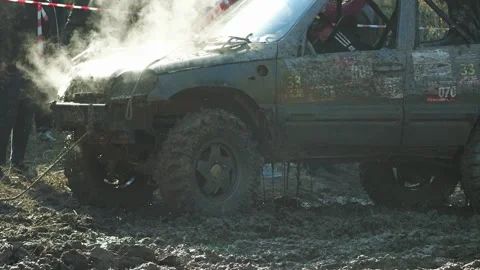 Rugged 4x4 vehicle stuck in deep mud during an extreme off-road competition Stock Footage 345495006