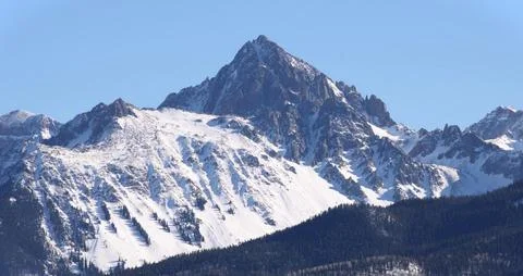 Rugged Alpine Mountain Peak Covered in Fresh Winter Snow Stock Photos