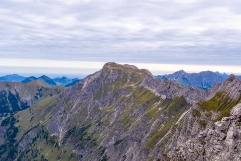 Rugged Alpine Ridge Beneath Clouded Sky Stock Photos