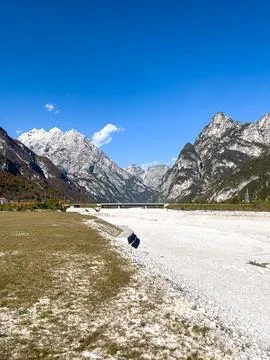 Rugged Alpine Valley with Dry Riverbed and Mountains Stockfoto's