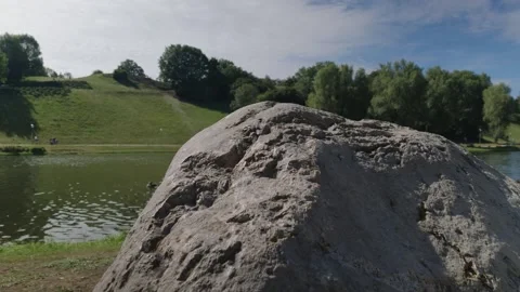 Rugged Boulder Texture Close Up, Lake and Hill Blurred Background Vídeo Stock 343026578
