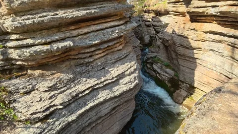 Rugged canyon walls frame a narrow rushing stream. Rosomac Canyon, Serbia Stock Footage 335535552