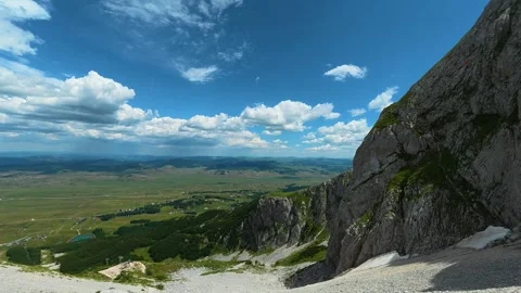 Rugged cliff face overlooks vast green valley below. Savin Kuk peak, Montenegro 스톡 동영상 342980253