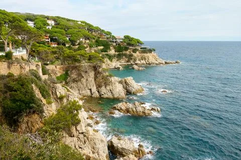 Rugged cliffs and lush greenery frame the vibrant turquoise waters of the med 스톡 사진