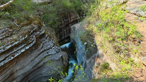 Rugged cliffs frame a rushing stream below. Rosomac Canyon, Serbia Stockbeeldmateriaal 335535781
