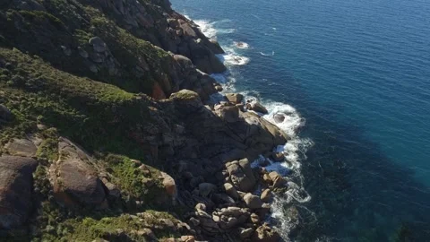 Rugged cliffs with ocean aerial Stock Footage 261345843