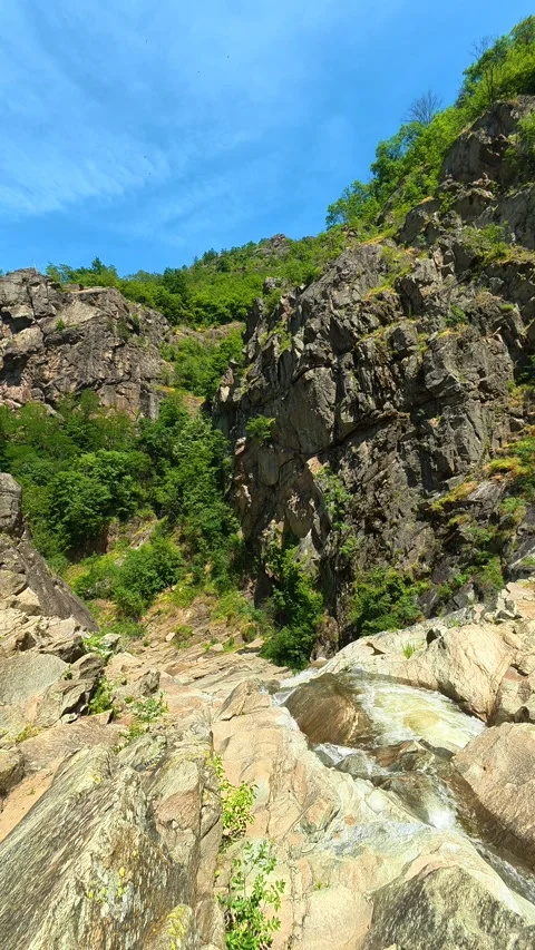 Rugged cliffs tower under clear blue skies. Vucjanka Canyon, Serbia. Vertical Stock Footage 341130891