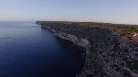 Rugged Coastal Cliff dropping to Deep Blue Sea, Forested Plateau, Aerial Shot Video stock 340629134