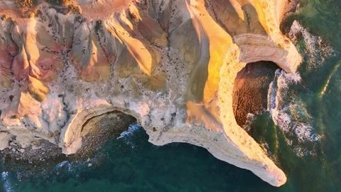 Rugged coastal cliffs and coves in late golden lighting Stock Footage 321790474