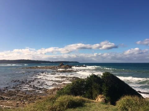 Rugged Coastline Australia Sunny Day Blue Sky Waves crashing on rocky coastline Stock Photos