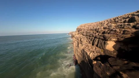 Rugged coastline with dramatic cliffs overlooking turquoise waters Stock Footage 346076940