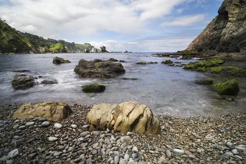 Rugged coastline with long exposure ocean water Stock Photos