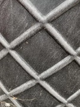 A rugged, dark diamond-plate pattern 写真素材