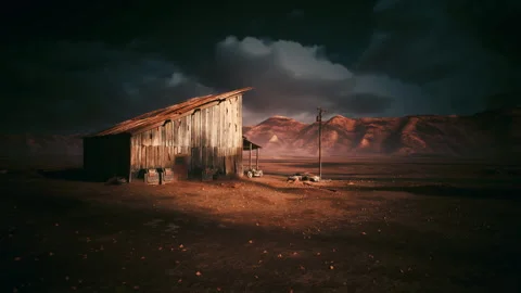 Rugged desert hideout glowing during twilight with scattered debris Stock Footage 334332877