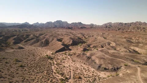 Rugged Desert Terrain With Distant Mountains Vídeo Stock 209292549