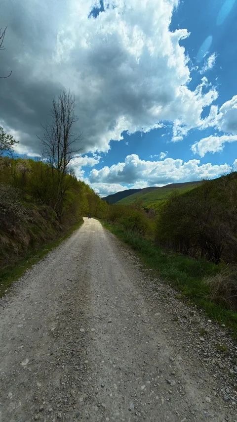 Rugged dirt path winds through green hills. Tupavica area, Vertical Vídeo Stock 335947158