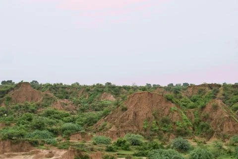 Rugged Eroded Ridges with Green Shrubs Stock Photos