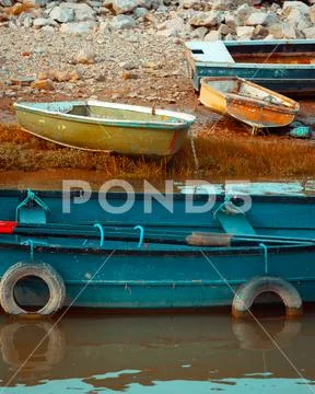 Rugged Fishing Boats at Low Tide in Muddy Harbour Stock Photos
