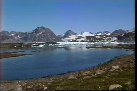 A rugged icy landscape sits at the base of a mountain range in Iceland. Stock Footage