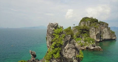 Rugged karst islet standing alone in turquoise shallows Vidéo 71298170