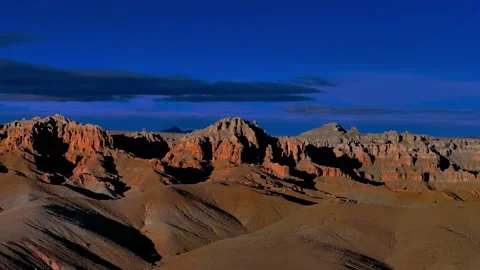 Rugged Landscape with Striking Red Rocks and Dark Sky Tibet China 動画素材 346737725