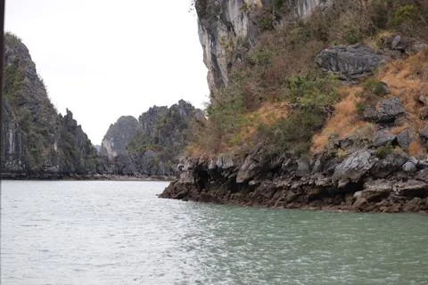 Rugged Limestone Cliffs and Tranquil Waters of Halong Bay, Vietnam Stock Photos