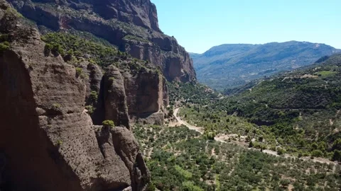 Rugged limestone mountains with olive groves in Greece Stock Footage 314955890