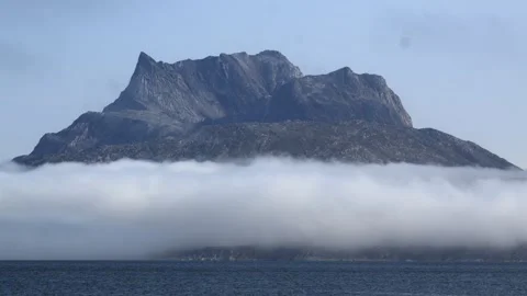 Rugged Mountain Above Low Sea Fog North of Nuuk, Greenland Stock Footage 345536207