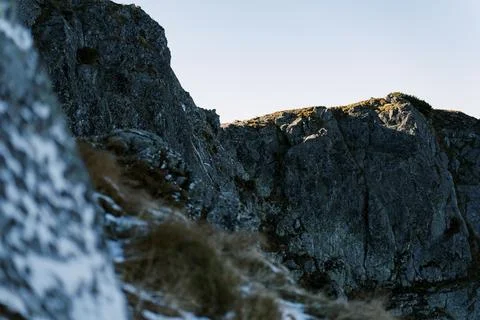 Rugged Mountain Cliffs with Light and Shadow Stockfoto's