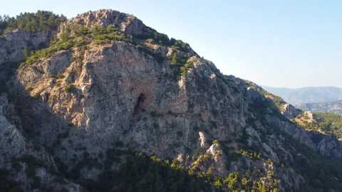 Rugged Mountain Landscape with Rocky Cliffs and Sparse Vegetation Stock Footage 318043659
