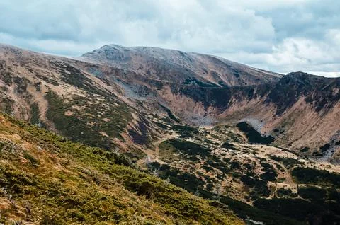Rugged Mountain Landscape Under Cloudy Sky Stock Photos
