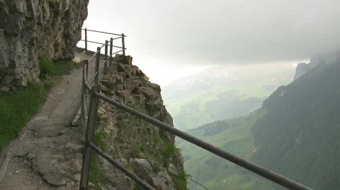 Rugged mountain path against cloudy sky Stock Footage 736864