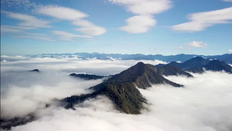 Rugged mountain peaks above clouds, aerial view, Papua New Guinea Stock Footage 115423588