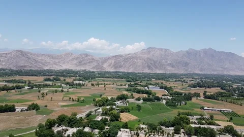 Rugged Mountain Range and Lush Valley Floor Stock Footage 274868454
