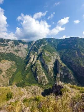 Rugged mountain range with deep valley and lush greenery Stock Photos