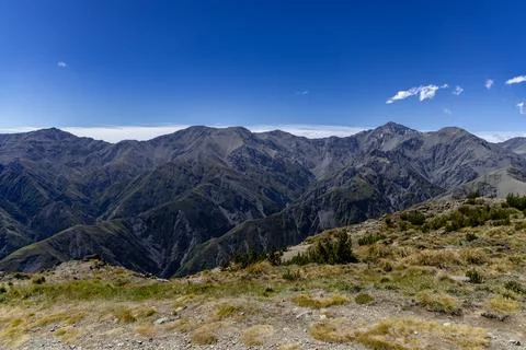 Rugged Mountain Range Under Clear Blue Sky 스톡 사진