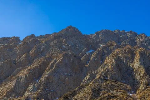 Rugged Mountain Range Under Clear Blue Sky 스톡 사진