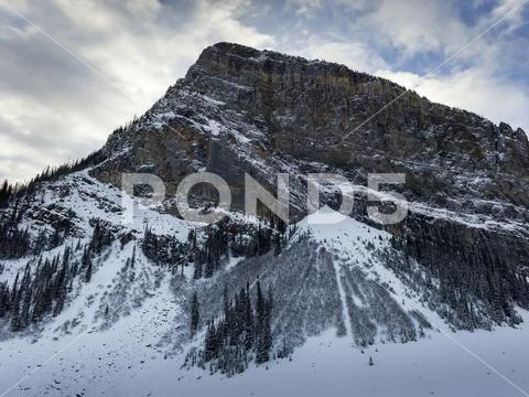 Rugged mountain with snow in winter; Lake Louise, Alberta, Canada Stock Photos