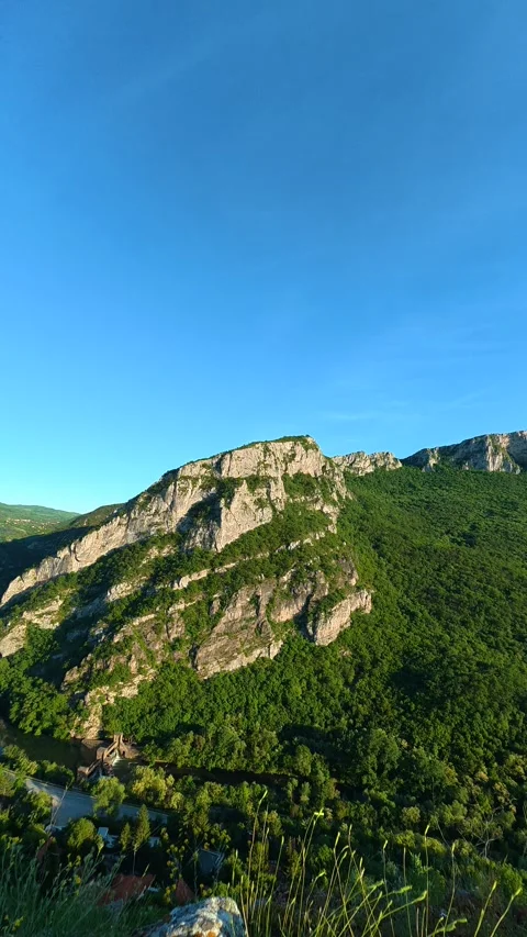 Rugged mountains rise under clear blue skies. Sicevo Gorge, Serbia. Vertical Stock Footage 337058145