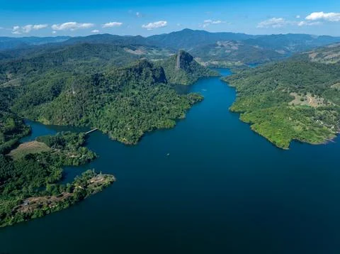 Rugged Mountains Surrounding Pristine Blue River Basin Under Clear Sky Wide.. Stock Photos