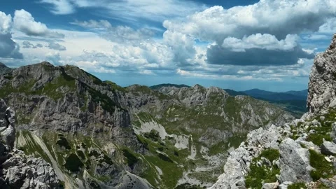 Rugged peaks rise under vast, fluffy clouds. Savin Kuk peak, Montenegro Stock Footage 342979134