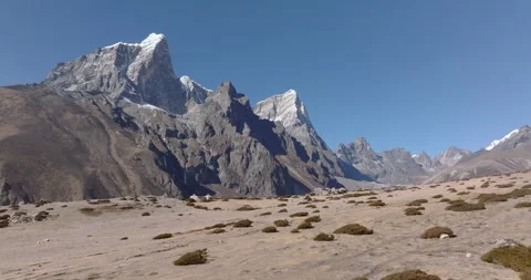 Rugged plain with scattered bushes under dry mountains, Everest region Nepal Stock Footage 331831416