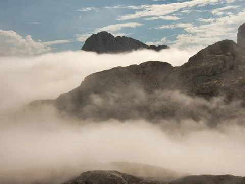 Rugged ridge above cloud inversion panorama - Elevated hiking trail on a ro.. Stock Photos