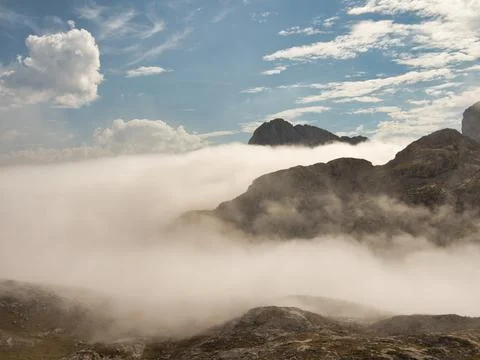 Rugged ridge above cloud inversion panorama - Elevated hiking trail on a ro.. Stock Photos